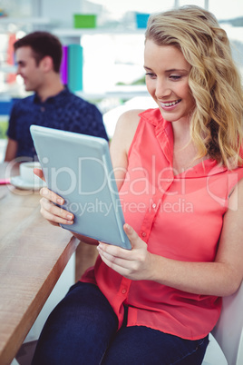 Smiling creative businesswoman working with co-workers