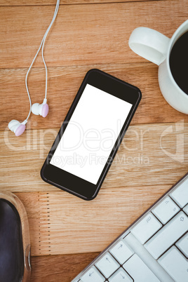 Black smartphone with cup of coffee