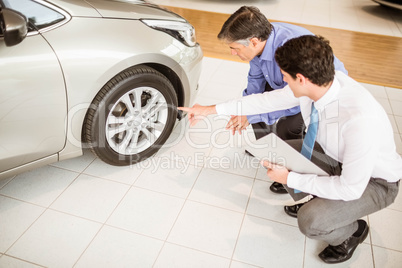 Salesman showing somethings to a man