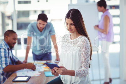 Young creative worker using tablet