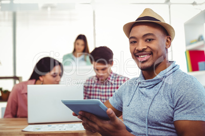 Young creative worker smiling at camera