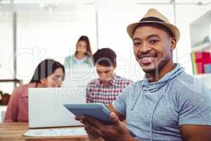 Young creative worker smiling at camera