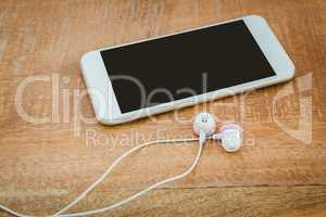 White smartphone with white headphones