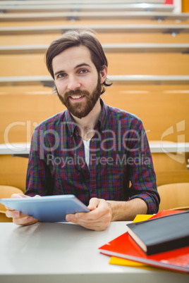Student in lecture hall using tablet