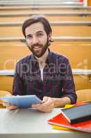 Student in lecture hall using tablet