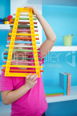 Smiling girl holding a xylophone