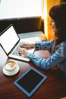 Mature student using laptop in cafe