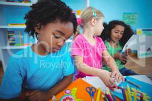 Happy kids using modelling clay together