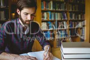 Hipster student studying in library