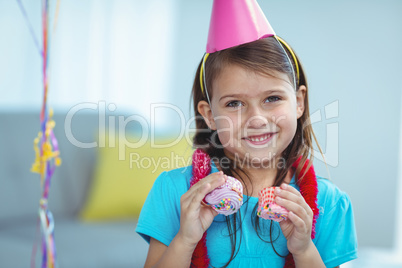 Smiling kid holding small buns