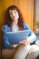 Mature student using tablet in cafe