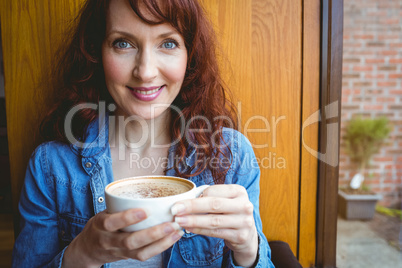 Mature student having coffee in cafe