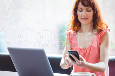 Mature student using laptop in cafe