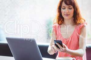 Mature student using laptop in cafe