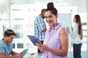 Young creative worker using tablet