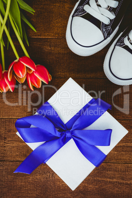 View of sneakers and blue gift