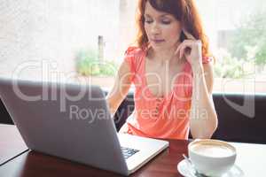 Mature student using laptop in cafe