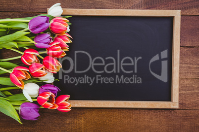 Bouquet of colored flowers against black board