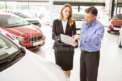 Focused businessman undersign a car contract
