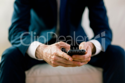 Businessman texting on the couch