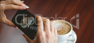 Woman taking a photo of her coffee