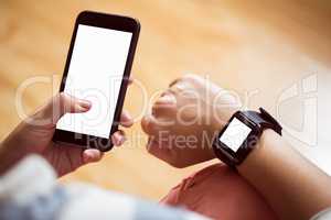 Asian woman using smart watch and phone