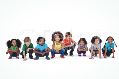A row of children crouching down together