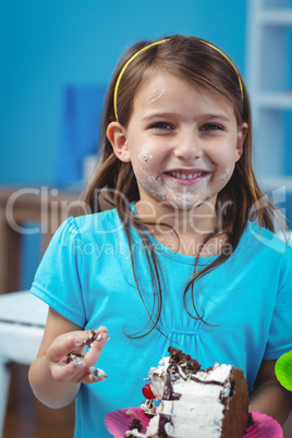 Happy kid eating birthday cake