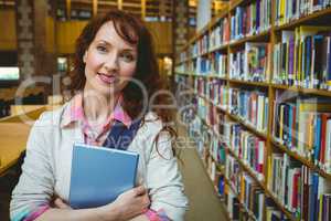 Mature student in the library using tablet