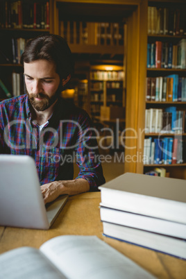 Hipster student studying in library