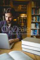 Hipster student studying in library