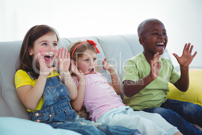 Happy kids laughing while sitting down