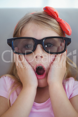 Close up of a girl wearing 3d glasses for a moive