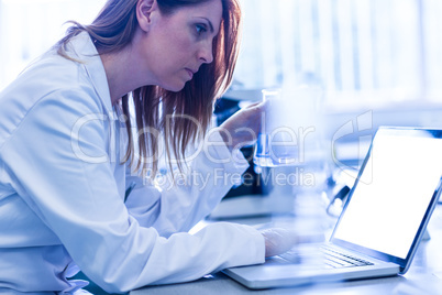 Scientist working with a laptop in laboratory