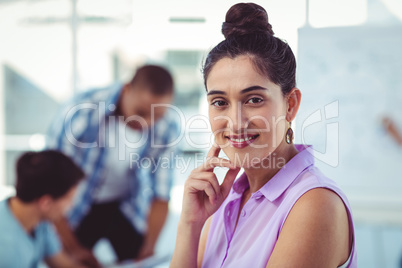 Young creative worker smiling at camera