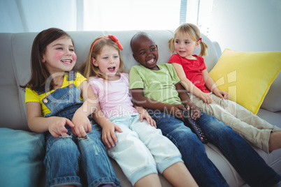 Happy kids laughing while sitting down
