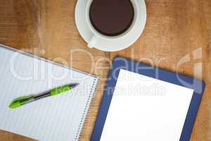 View of a blue tablet and a coffee