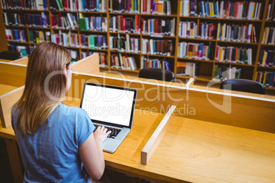 Mature student in the library using laptop