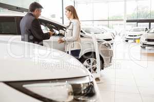 Salesman showing a car to a client