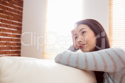 Asian woman relaxing on couch