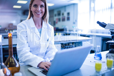 Scientist working with a laptop in laboratory