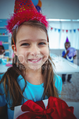 Smiling girl holding a present