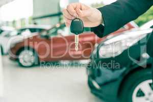 Saleswoman holding a car key