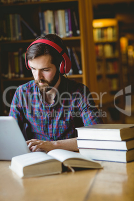 Hipster student studying in library