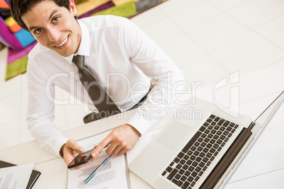 Smiling salesman having a phone call