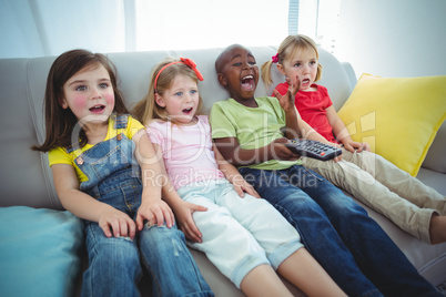 Happy kids laughing while sitting down