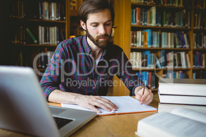 Hipster student studying in library