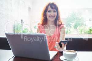 Mature student using laptop in cafe