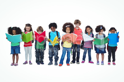 A row of children standing together reading books