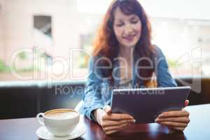 Mature student using tablet in cafe